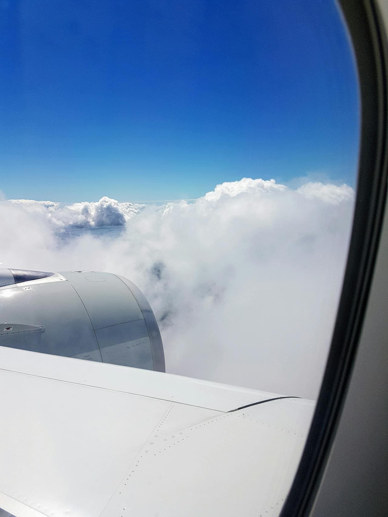 View from airplane window over clouds